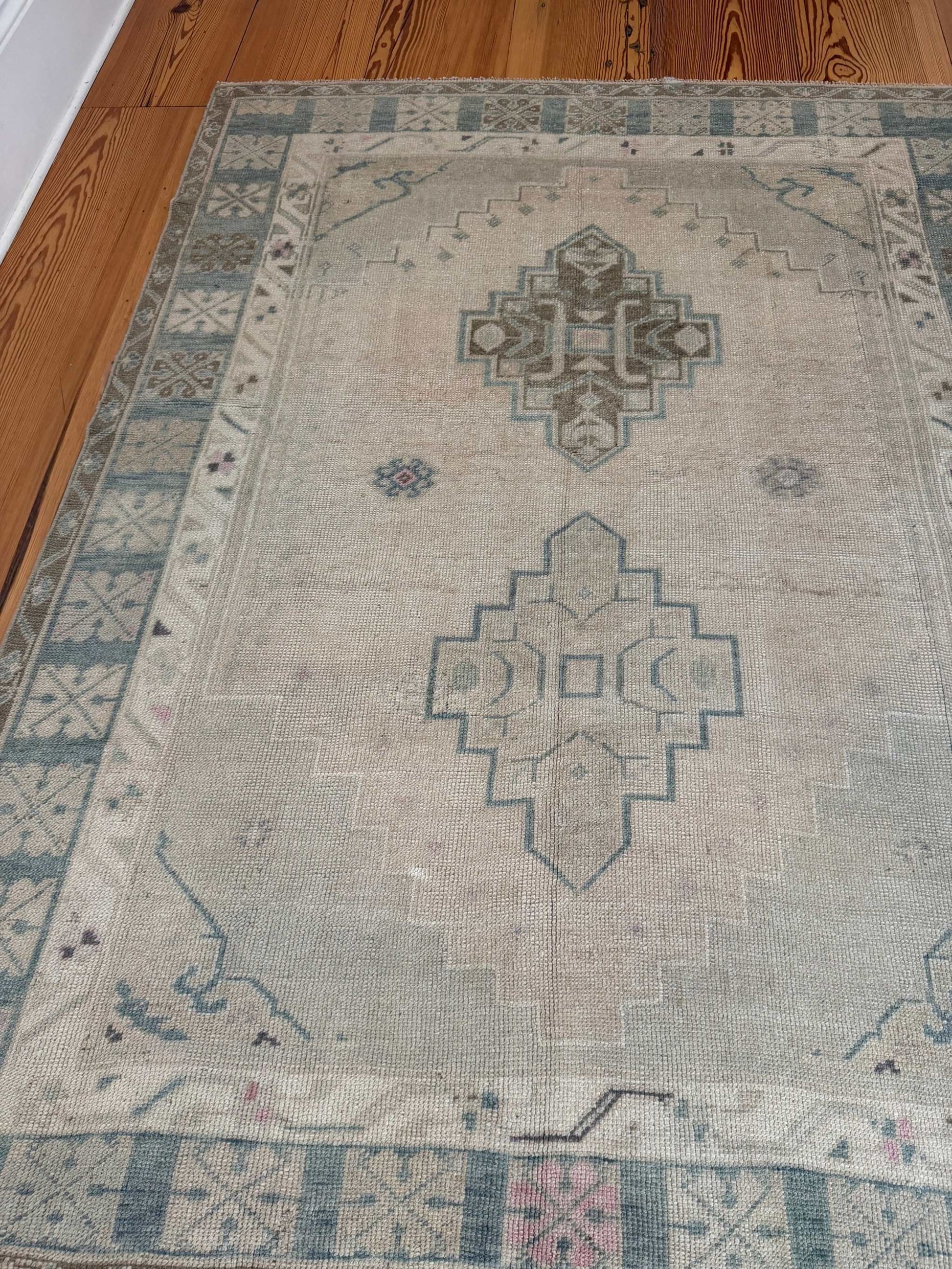 4'11" x 6'6" Turkish hand-knotted square area rug with neutral background and blue-green accents
