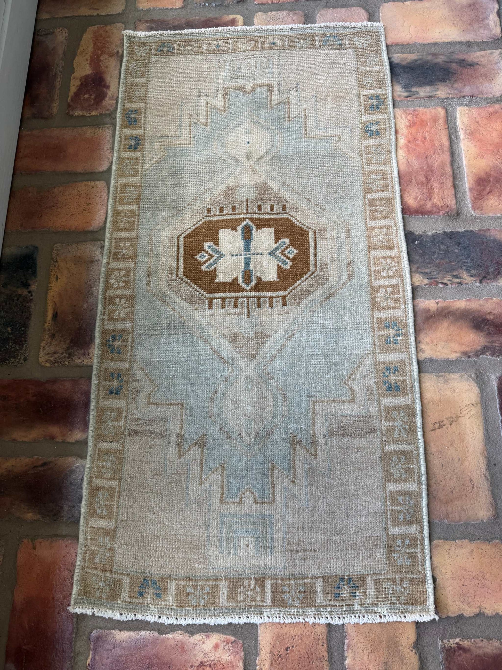 Small vintage Oushak mat with pale blue-gray, beige, and brown hand-knotted wool design
