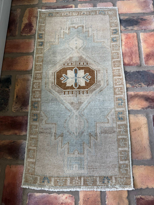 Small vintage Oushak mat with pale blue-gray, beige, and brown hand-knotted wool design