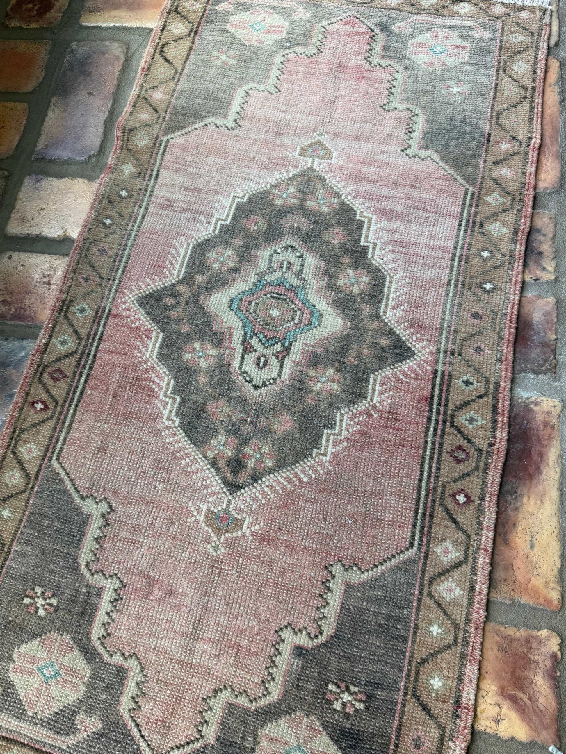 Small hand-knotted Turkish mat with brick red and brown tones, vintage Oushak rug