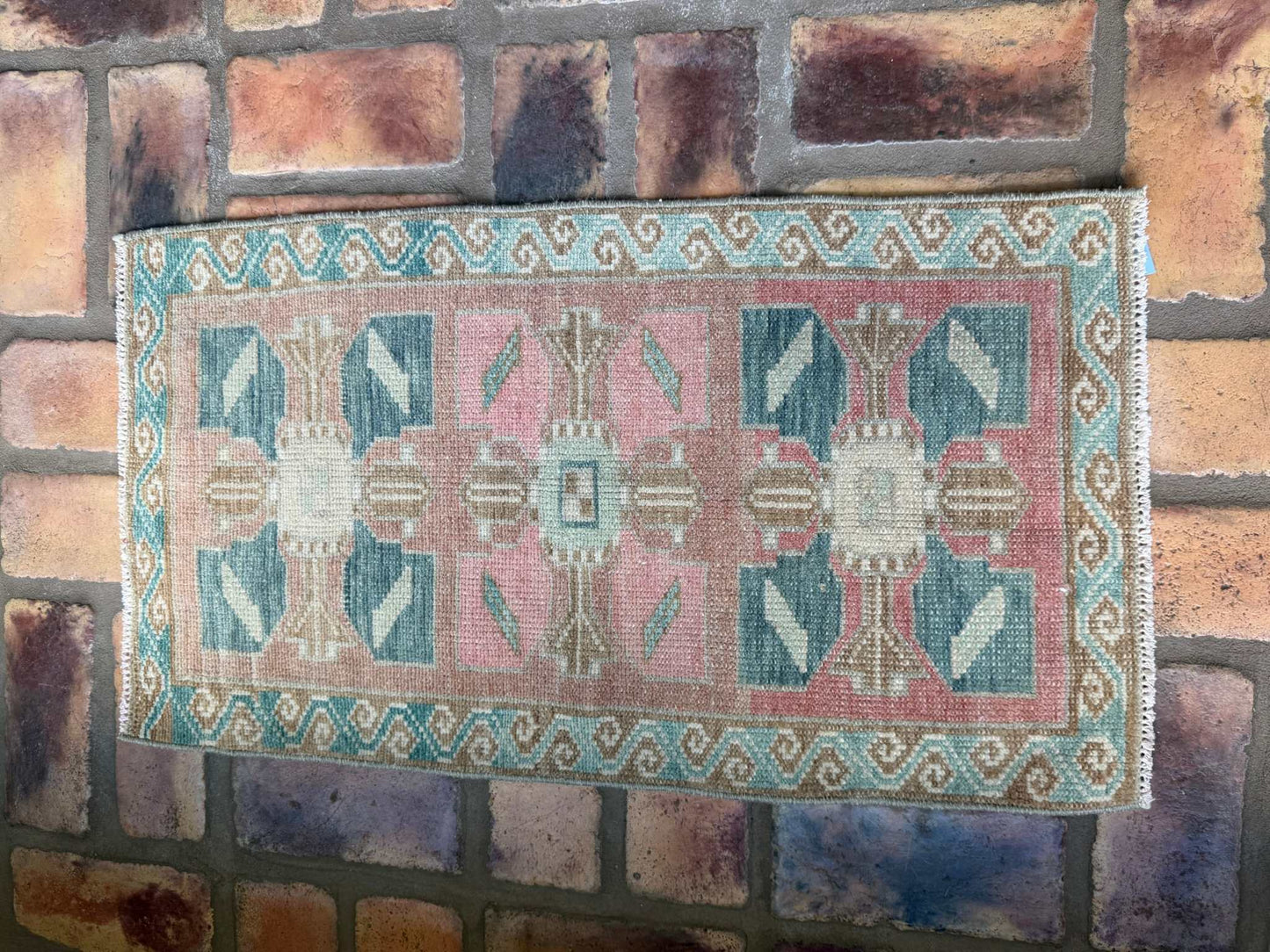 Small vintage Turkish Mat with blues, pink, and red-brown hand-knotted wool design