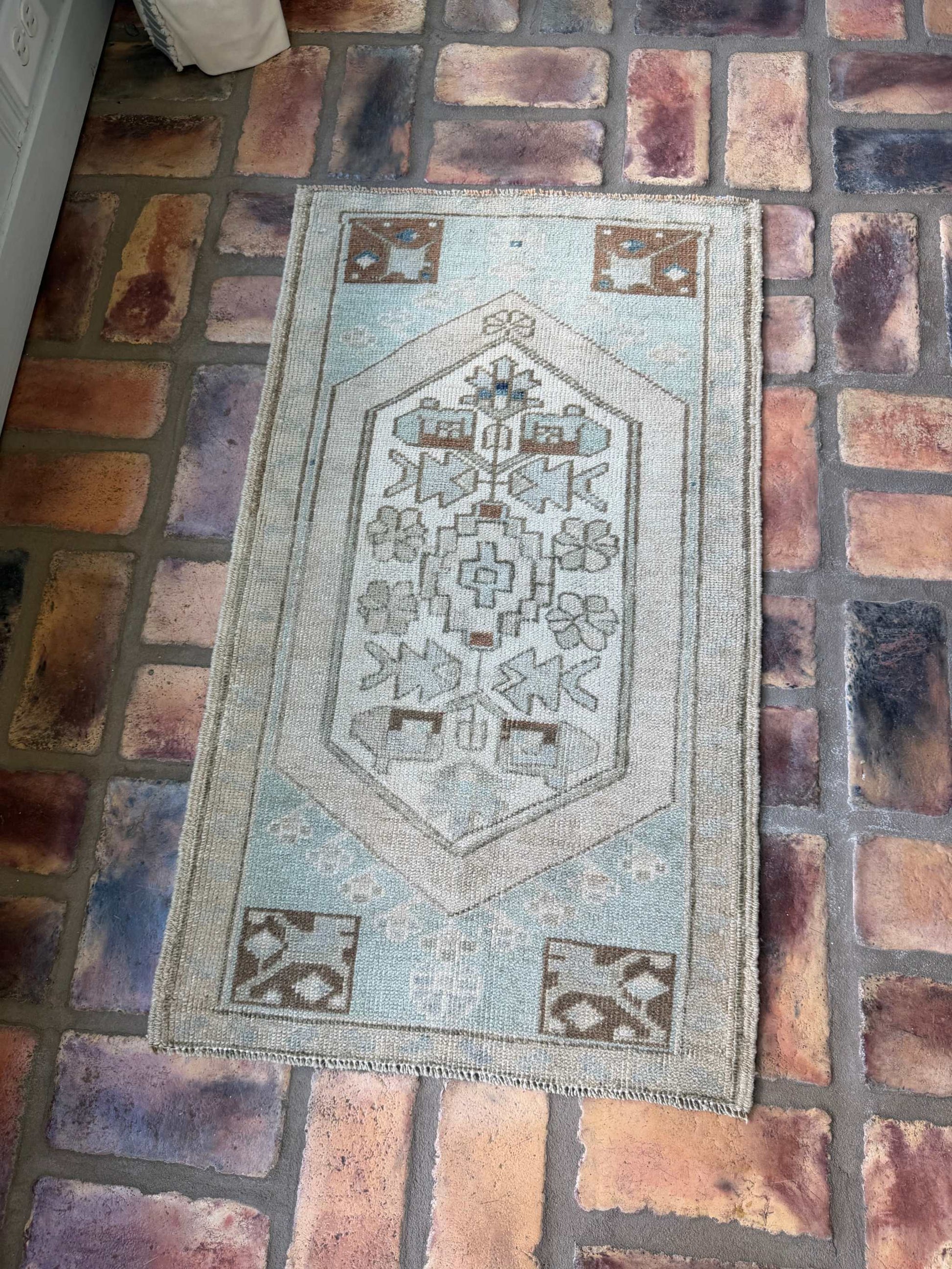 1'9" x 3' vintage hand-knotted Oushak rug in pale blue, beige, and brown colors
