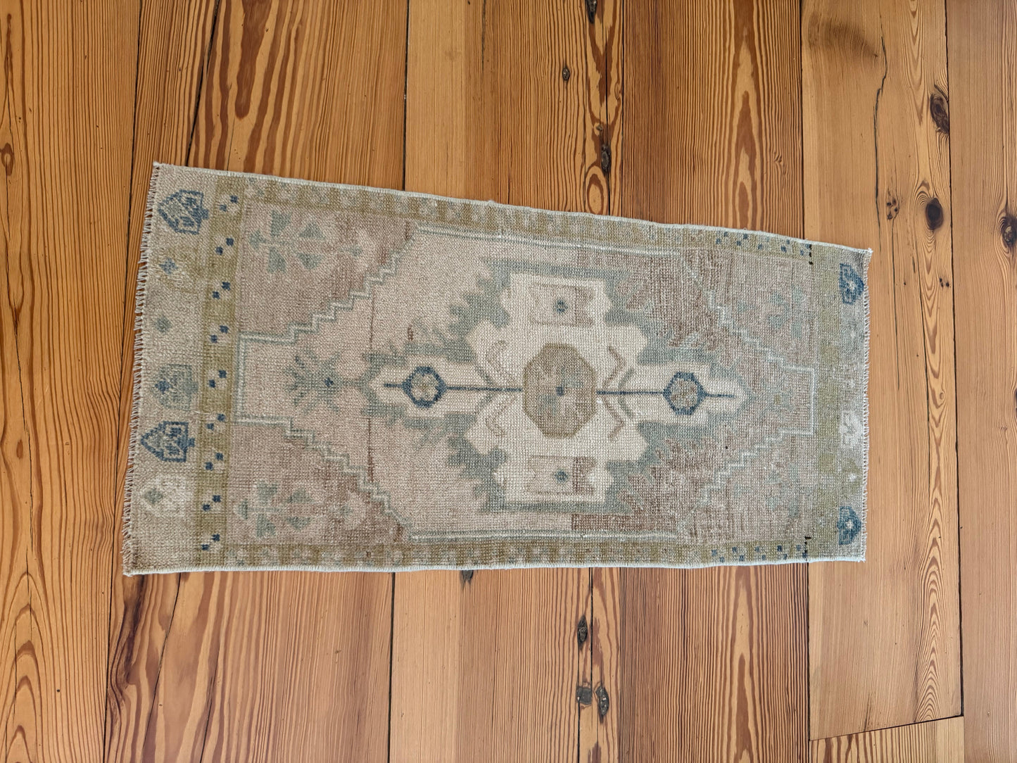 Small Oushak Rug with green and tan hand-knotted wool design, vintage style