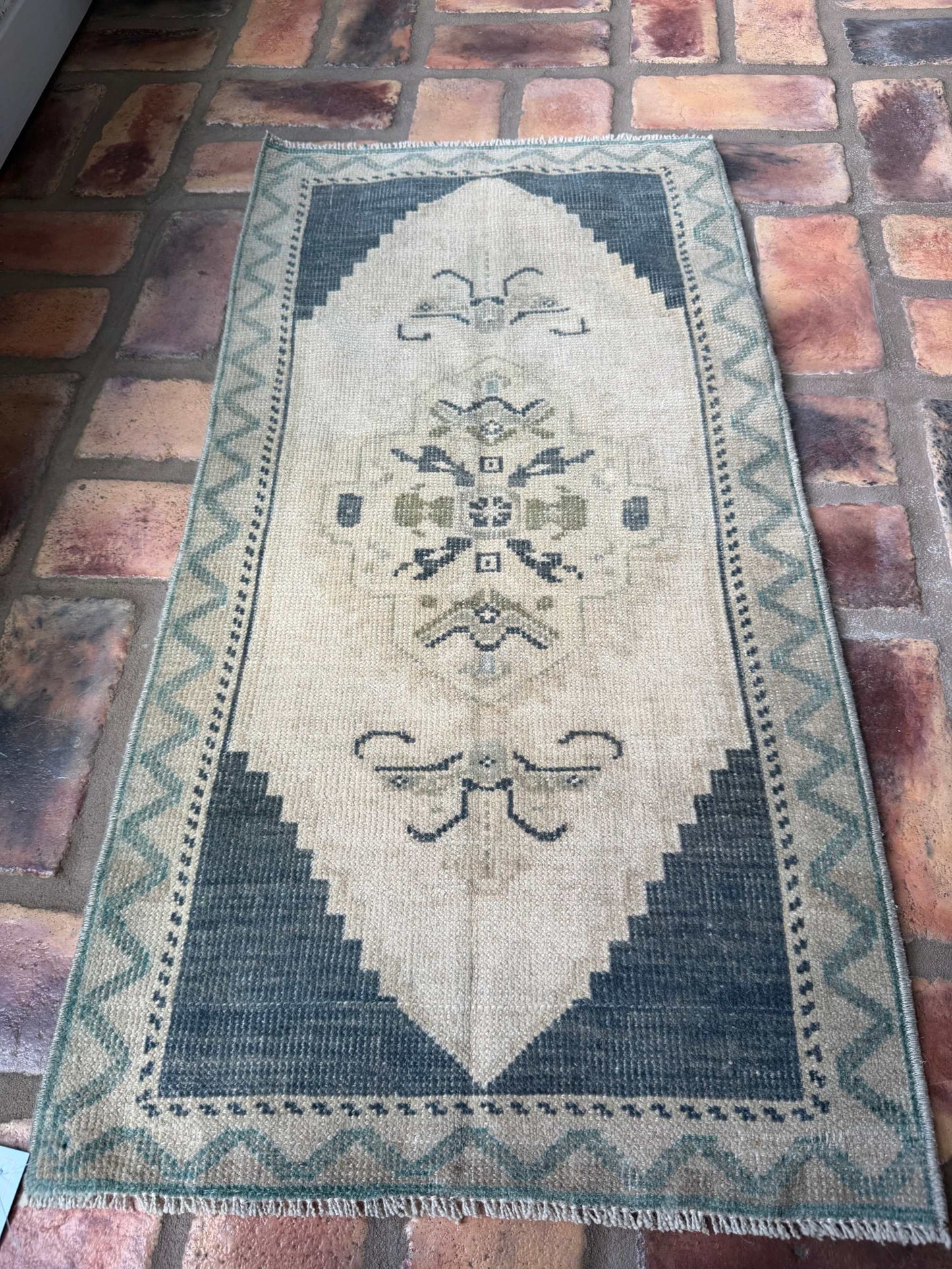Small hand-knotted vintage Oushak rug in deep slate blue and beige colors