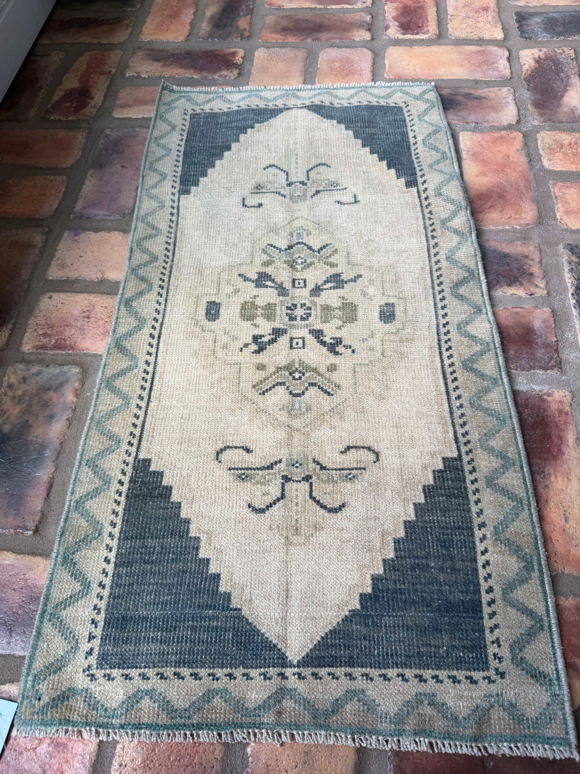 Small hand-knotted vintage Oushak rug in deep slate blue and beige colors