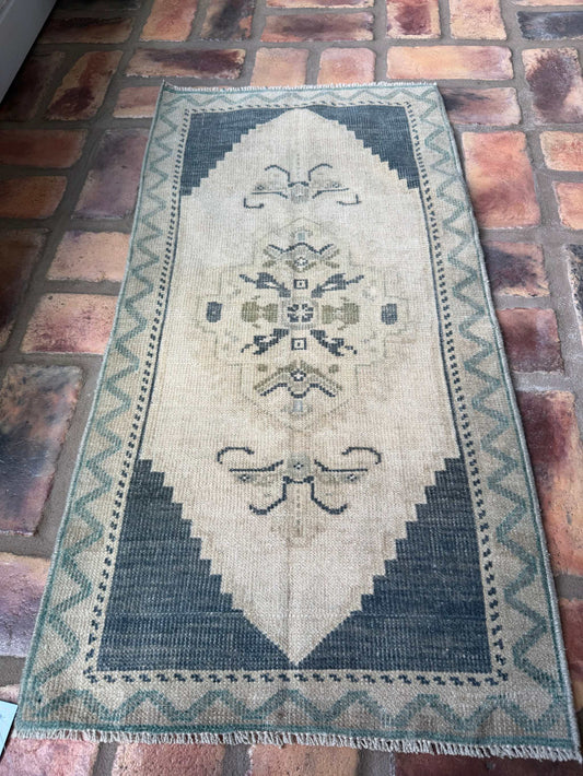Small hand-knotted vintage Oushak rug in deep slate blue and beige colors