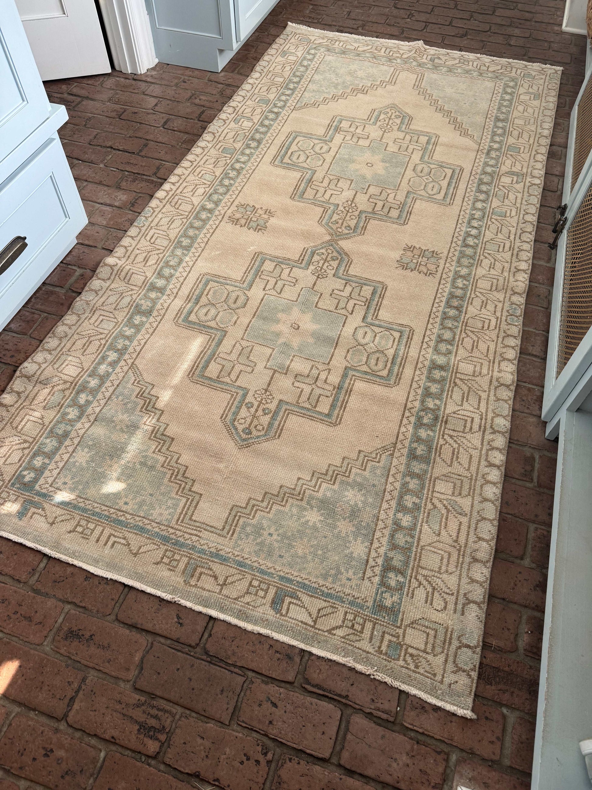 4'4" x 9' area rug with pale blue-aqua and beige double medallion design.