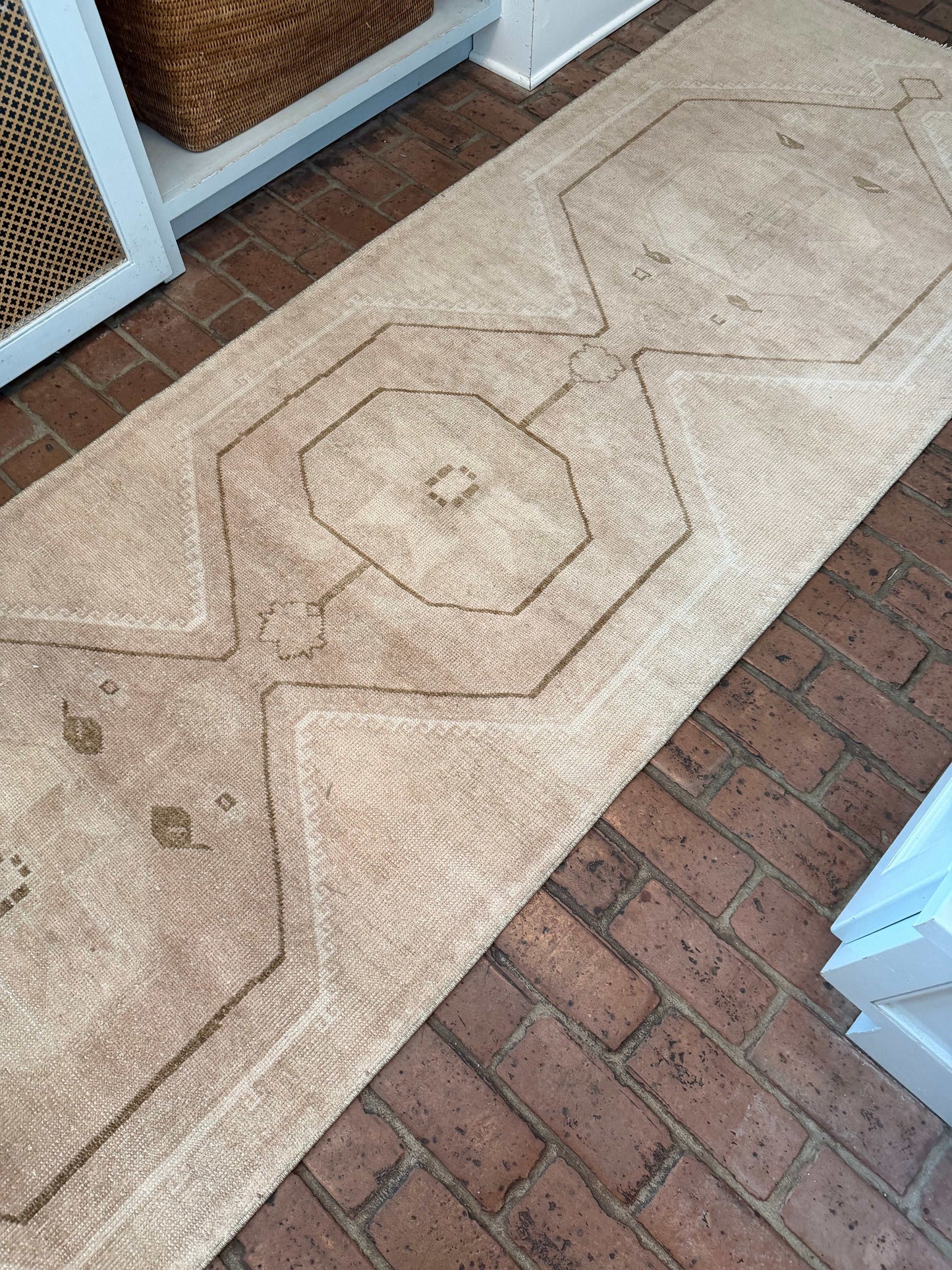 Decorative concrete path with geometric pattern on a brick surface