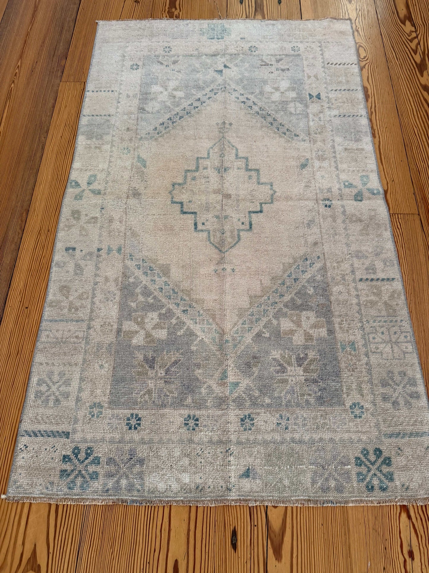 Decorative rug with geometric pattern on a wooden floor