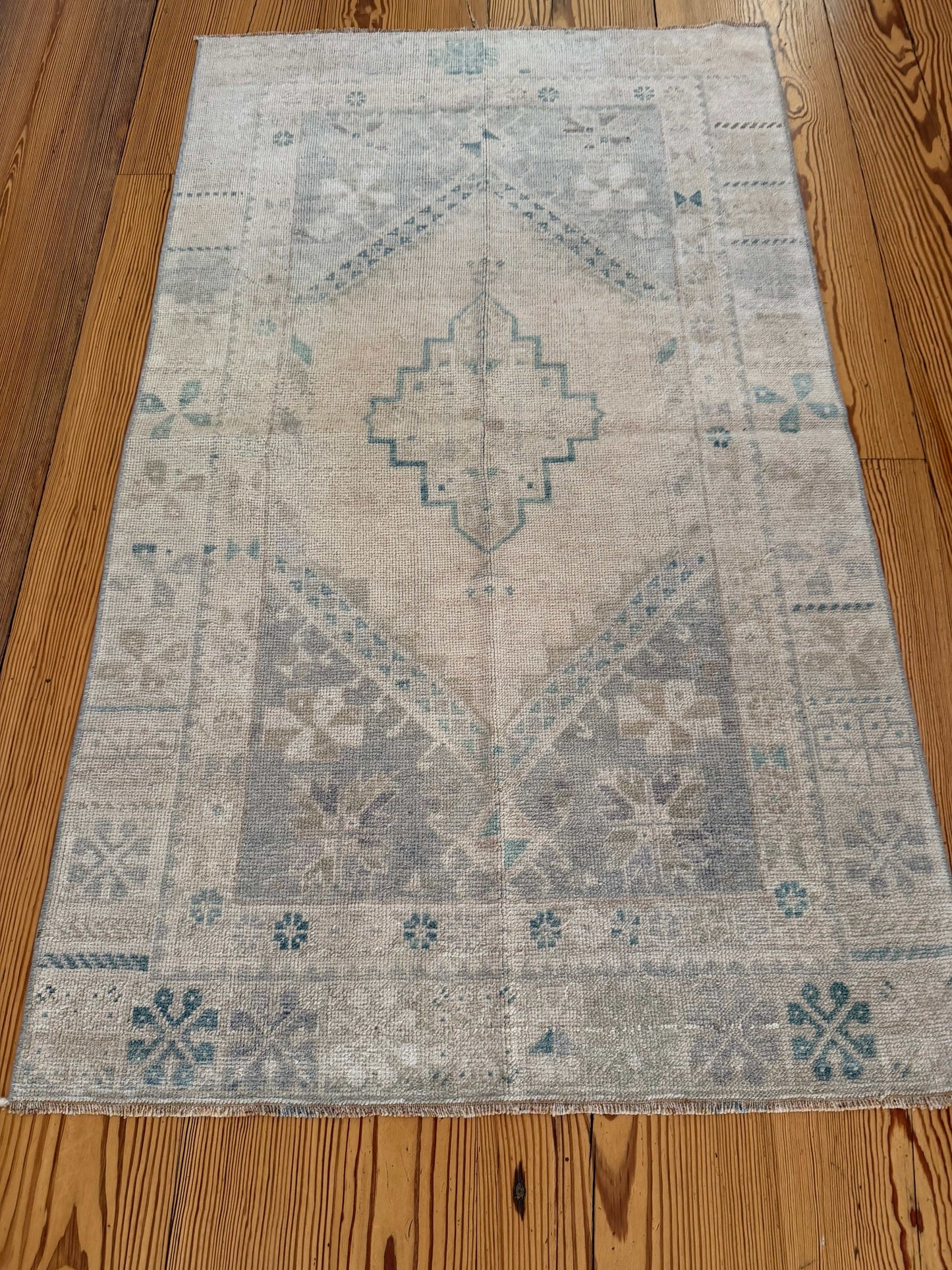 Decorative rug with geometric pattern on a wooden floor