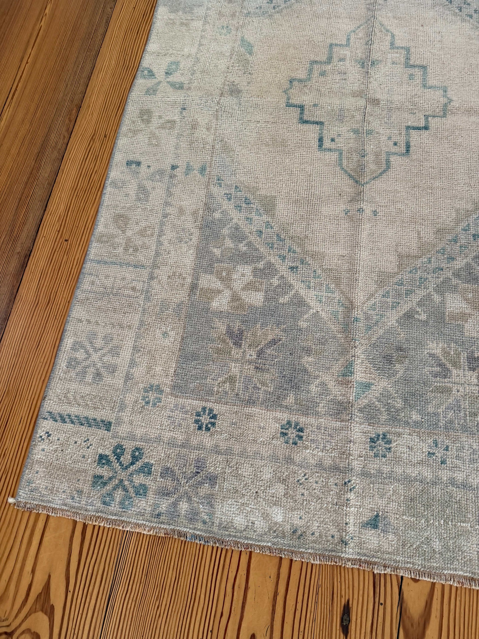 Decorative rug with geometric pattern on a wooden floor