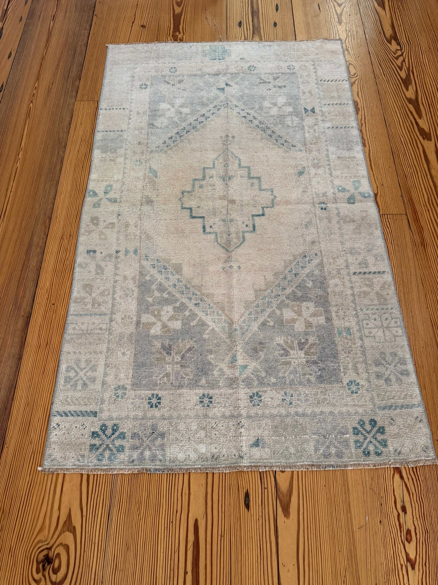 Patterned rug on a wooden floor