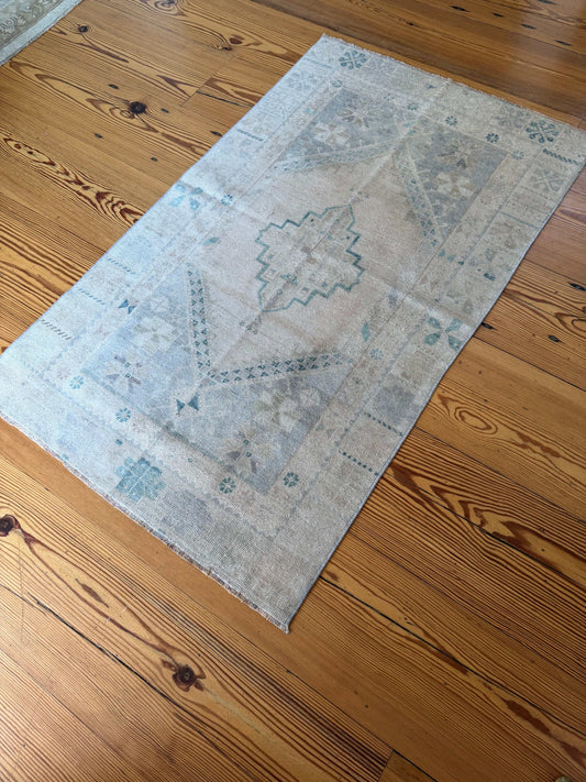 Decorative rug with geometric pattern on a wooden floor