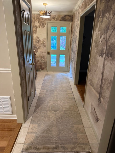 gray rug runner with wallpaper hallway