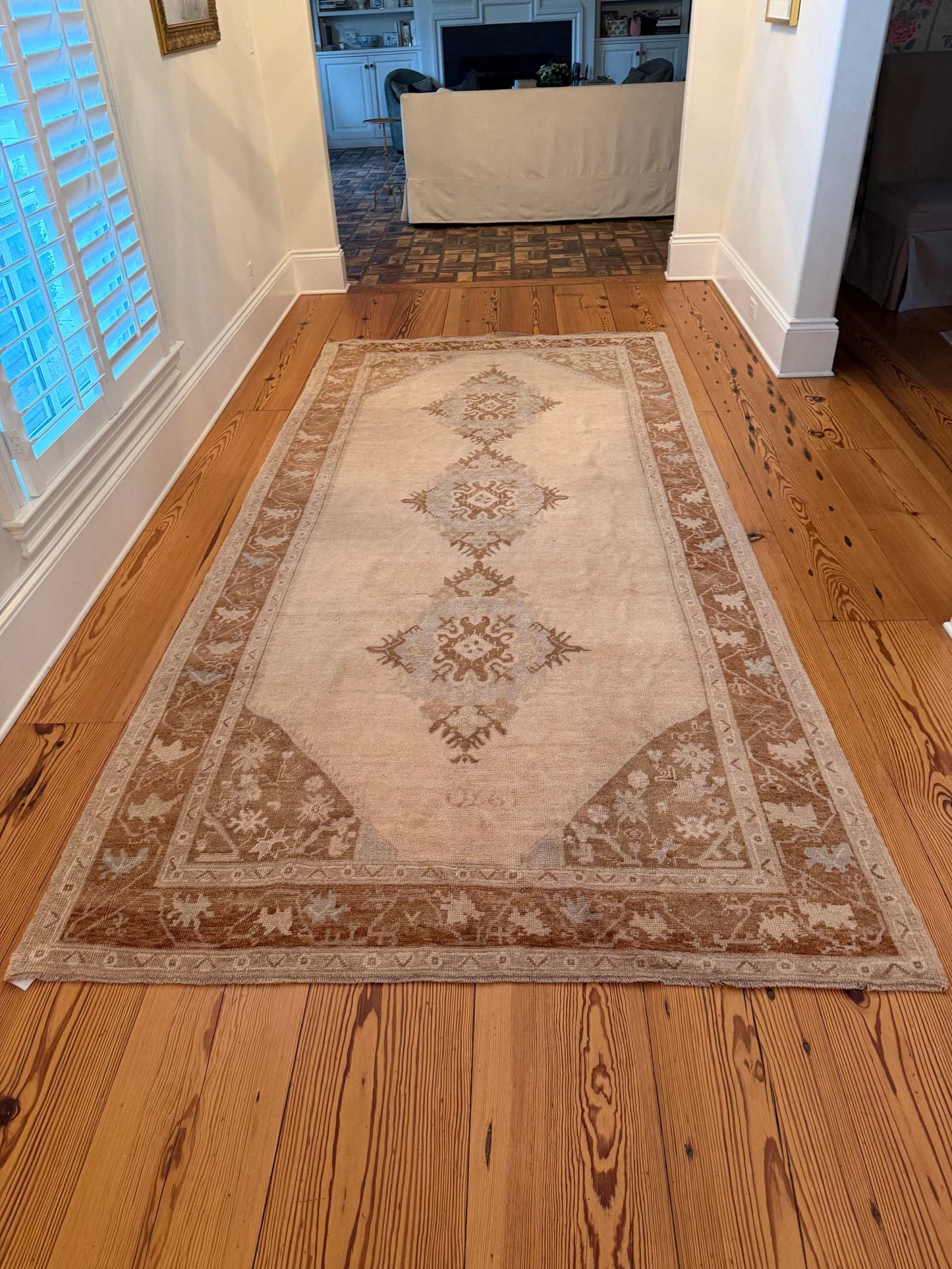 Decorative rug with geometric pattern on a wooden floor