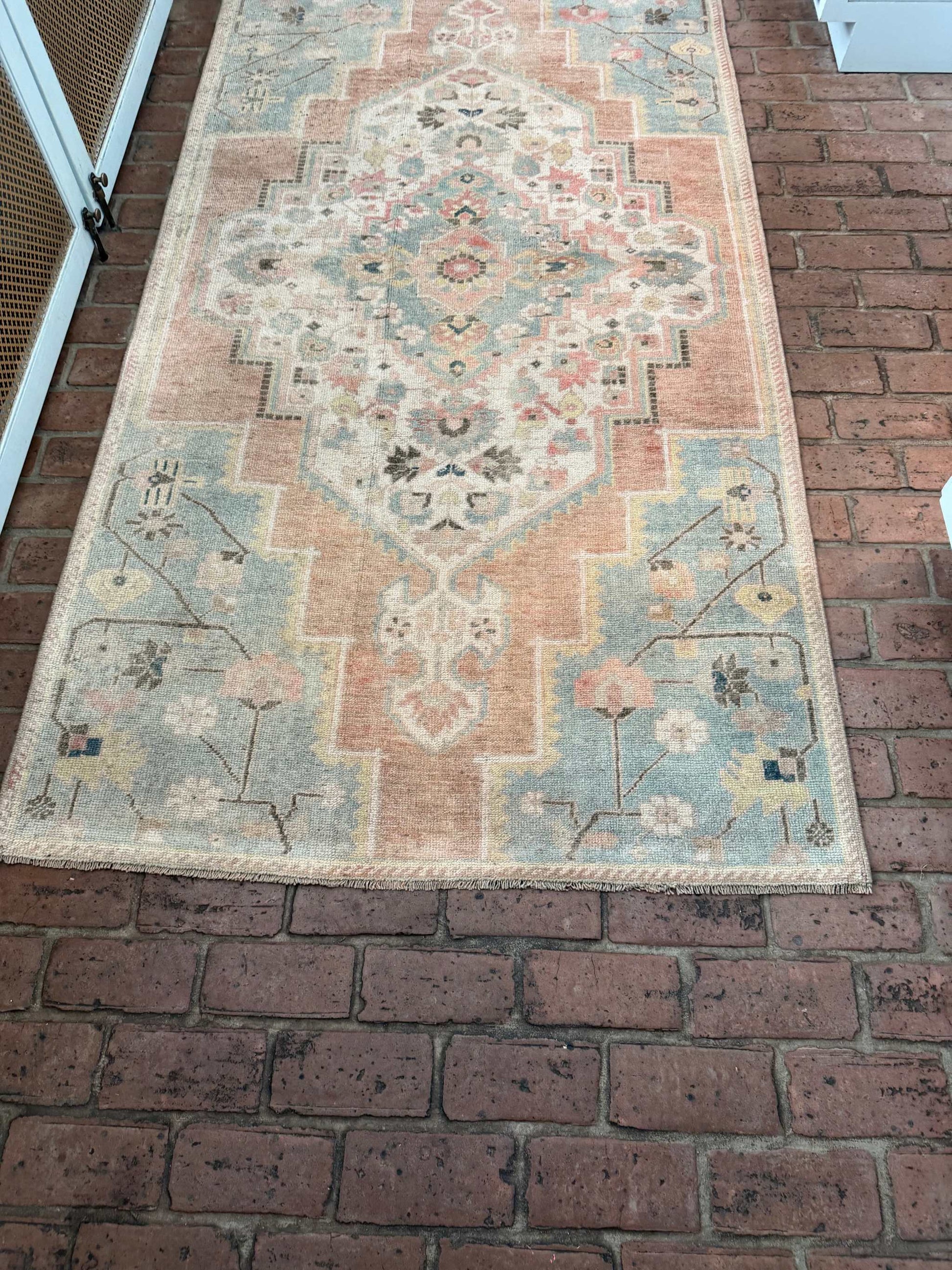 3'10" x 7'5" hand-knotted area rug with blue, rust, and gold details