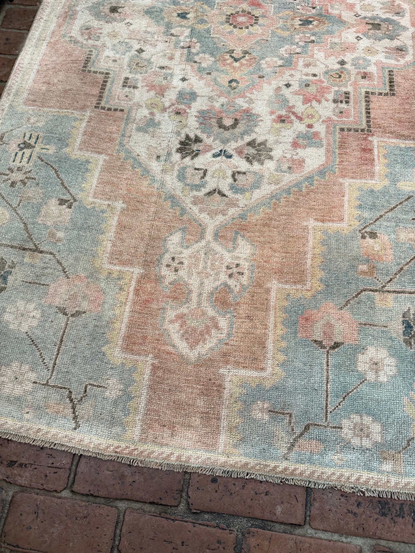 3'10" x 7'5" hand-knotted blue and rust area rug with gold details