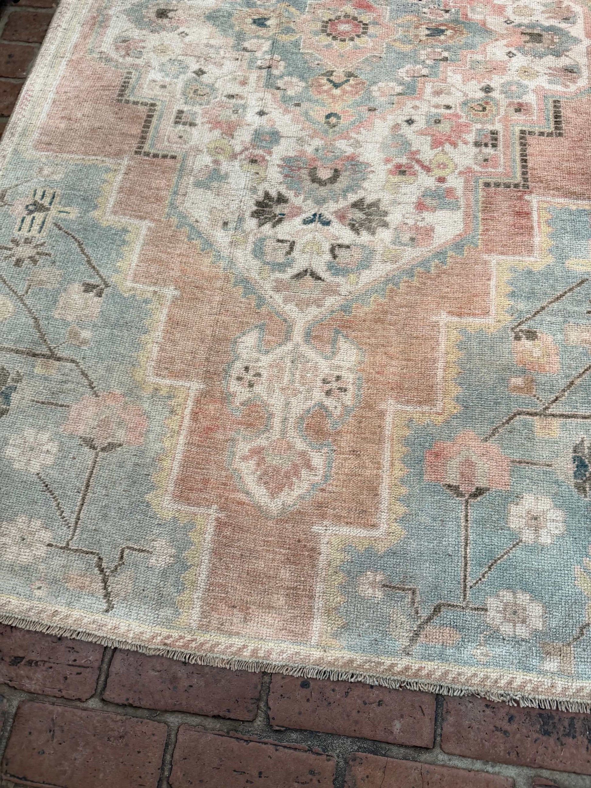 3'10" x 7'5" hand-knotted blue and rust area rug with gold details