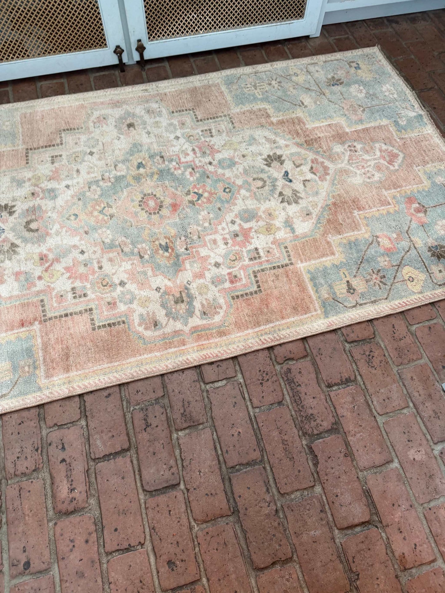 3'10" x 7'5" hand-knotted area rug with blue, rust, and gold details