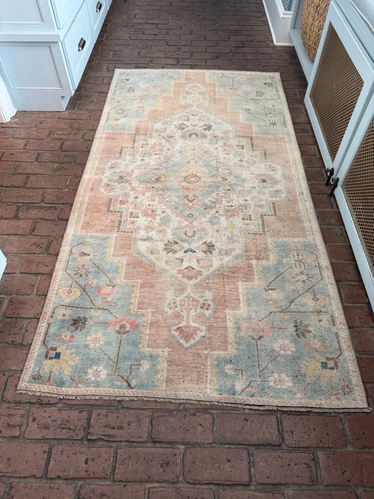 3'10" x 7'5" hand-knotted area rug with blue, rust, and gold details