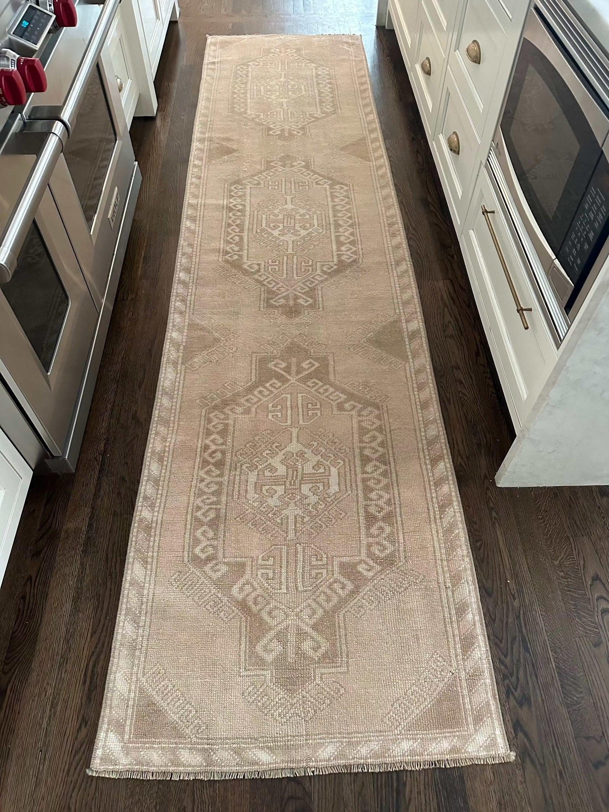 2’8” x 11’ runner in ivory, beige, and brown with geometric patterns on hardwood floor in kitchen hallway